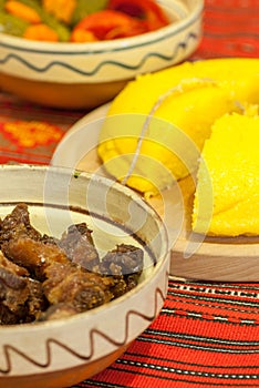 Romanian traditional winter season meal with polenta mamaliga fried pork scraps and pickled vegetables