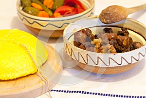 Romanian traditional winter season meal with polenta mamaliga fried pork scraps and pickled vegetables