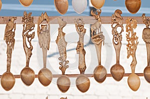 Romanian traditional wooden spoons. Set of handcrafted wooden spoons in a Romanian market. photo