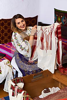 Romanian woman opening the costume chest