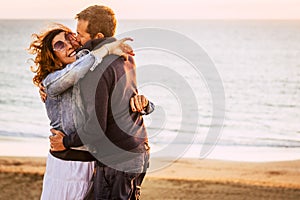 Romantic adult couple in love hug and have fun together with joyful. Concept of relationship man and woman embracing outdoor with