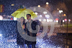 In the romantic ambiance of a rainy night, a happy couple walks through the city, sharing tender moments under a yellow