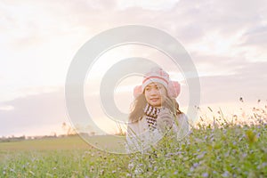 Romantic Asian beautiful girl walking in a field in sunset light. Winter, autumn life