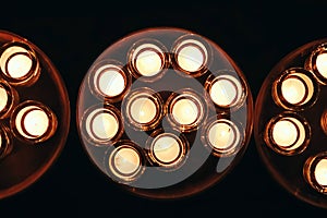 Romantic atmosphere, many small, lit candles on the table. Dark background