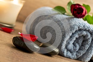 Romantic atmosphere with a red rose on top of rolled towel, lit