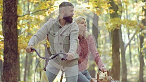 Romantic autumn couple in love. Portrait of cheerful young woman and bearded man with autumn leafs. Autumn beauty