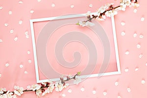 Romantic background with bouquet of flowers and gift box on pink. Top view with copy space