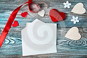 Romantic background with hearts and envelope on wooden background. T