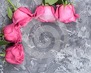 Romantic background. Red roses on a concrete table. Copy space. Top view. Flat lay