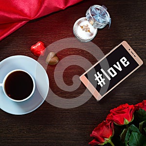 Romantic background with wedding ring, rose flowers, smartphone, cup of coffee and chocolate candy