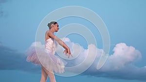 Romantic ballerina dancing ballet background clouds. Lightness move woman dancer