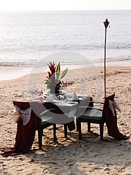 Romantic beach dining setting photo