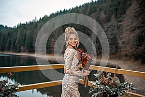 Romantic beautiful bride in luxury dress posing on the lake