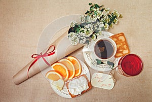 Romantic Birthday Breakfast.Cup of Coffee,Glass og red Beverage,Cut Orange,Biscuit with Cottage Cheese.Wish Card with Flowers.