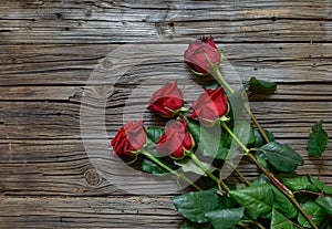 Romantic bouquet of red roses on a wooden surface