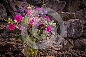 Romantic bouquet and rock wall background
