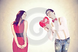 Romantic boy gives a heart to his girlfriend in Valentine?s Day