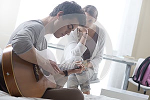 Romantic boy playing guitar for her girlfriend