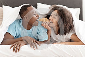 Romantic breakfast in bed, honeymoon and fun together in cozy hotel room