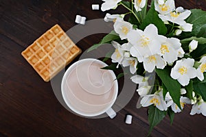 Romantic breakfast. Bouquet of jasmine. A cup of hot cocoa and Viennese waffles.