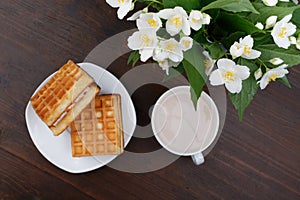 Romantic breakfast. Bouquet of jasmine. A cup of hot cocoa and Viennese waffles.