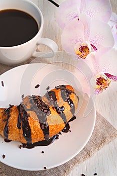 Romantic breakfast - croissant, chocolate, coffee and orchid bra