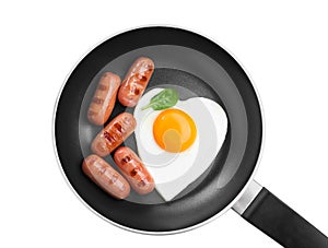 Romantic breakfast with fried sausages and heart shaped egg isolated on white, top view. Valentine`s day celebration