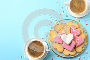 Romantic breakfast with heart shaped cookies and cups of coffee on color background