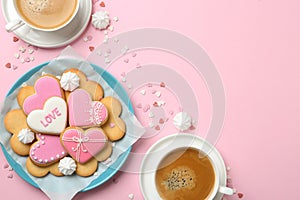 Romantic breakfast with heart shaped cookies and cups of coffee on color background