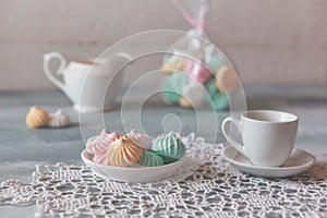 Romantic Breakfast with meringue cookies, white cups and creamer
