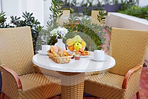 A romantic Breakfast is served on the terrace. Fresh fruit, pastries, jam and coffee are on the table in the open air