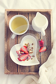 Romantic breakfast. Yogurt with granola and strawberry in bowl