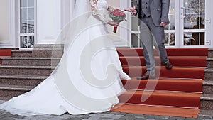 A Romantic Bride and Groom Couple Holding Hands on Wedding Day