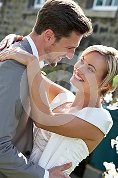 Romantic Bride And Groom Embracing Outdoors