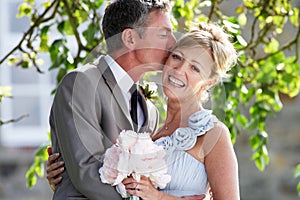 Romantic Bride And Groom Embracing Outdoors