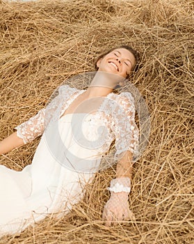 Romantic bride on haystack.