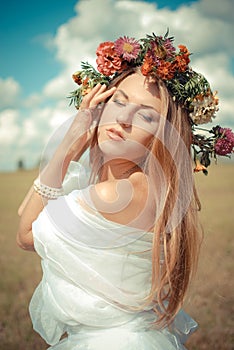 Romantic bride wearing flower wreath and chiffon