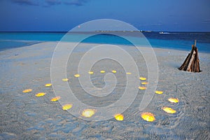 Romantic candle-lit heart on a private island