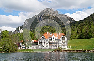 romantic Neuschwanstein castle and restaurant Zur Alpenrose in the Alps (Bavaria, Germany)