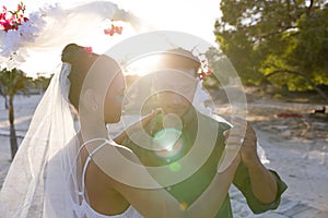 Romantic caucasian newlywed young couple dancing at beach at wedding ceremony during sunset