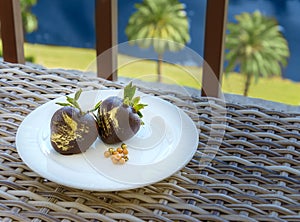 Romantic chocolate covered strawberries on a balcony