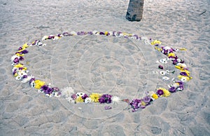 Romantic circle of flowers at the beach photo