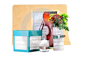 Romantic composition made of candle, flowers, songbook and box with a present. photo