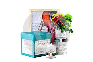 Romantic composition made of candle, flowers, songbook and box with a present. The concept of romantic atmosphere. photo