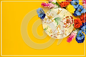 Romantic concept, decorative saucer for a cup of tea, flowers, yellow isolated background, top view, copy space
