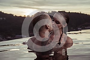 Romantic couple alone in infinity swimming pool