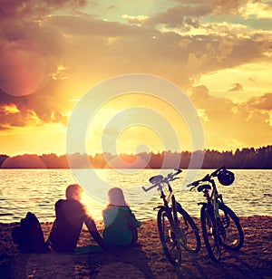 Romantic Couple with Bikes by the Lake photo