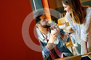 Romantic couple in cafe is drinking coffee and enjoying being together