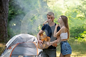 Romantic couple camping on spring landscape, man with guitar. Adventure for young lovers campers on nature. Hiking