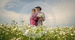 romantic couple among chamomile. love and romance. spring countryside.